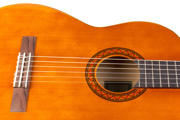 Acoustic guitar neck with body and strings on white background in close-up