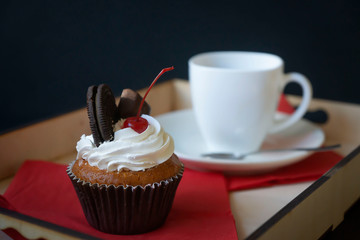 Freshly baked pastry, black coffee on a tray.
