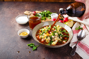 Cold Soup Okroshka with sausage, vegetables and kvass