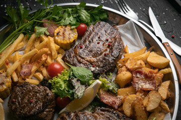 Meat grill set with wine on black wooden background