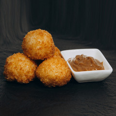 Rice balls with shrimp on a black plate
