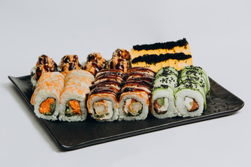 Sushi Set and sushi rolls served on stone slate