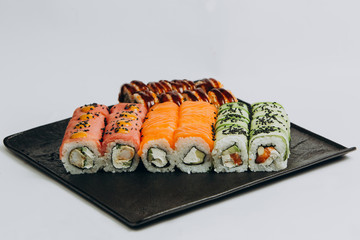 Sushi Set and sushi rolls served on stone slate