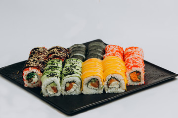 Sushi Set and sushi rolls served on stone slate