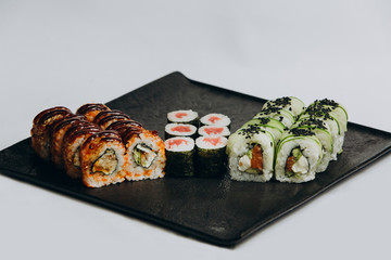 Sushi Set and sushi rolls served on stone slate