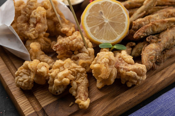 Fish fried in breadcrumbs, seafood. On a black background 