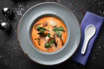 
TOM YAM is a traditional Thai soup. On a black background