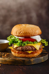Close-up of home made tasty burger on wooden table.