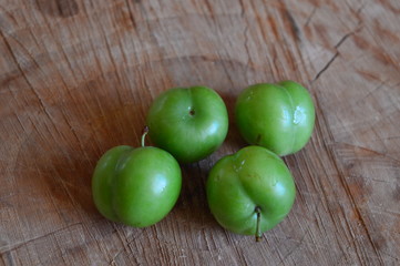 sour plums a wooden table