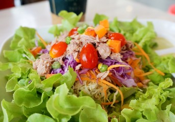 Tuna salad on a plate on the table.  Salad is a food that everyone likes to eat because it is not only delicious and useful but also helps in controlling weight.