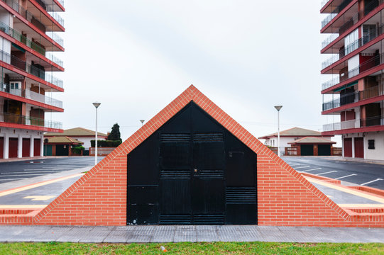 Entrance to a car parking made of bricks close to residential area