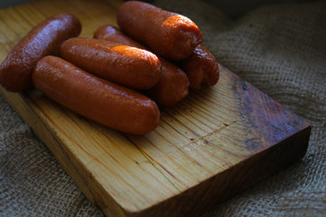 Fried sausages on a wooden board