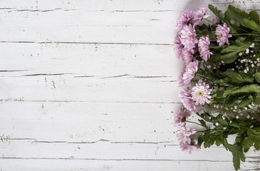 Fototapeta na wymiar pink flowers on a wooden background