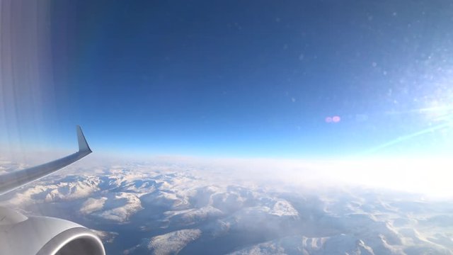 Aerial view over the snowy mountains of Northern Norway in the Arctic Circle during a beautiful winter day.
