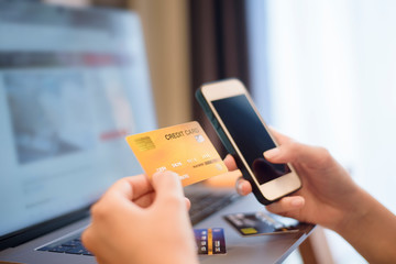 Woman hand is holding credit card, shopping online