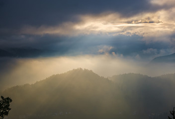 Autumn hazy day Berchtesgadener Land and mount Watzmann silhouette fragments in contra light cloudy view from Marxenhohe viewpoint, Bavarian prealps, Germany
