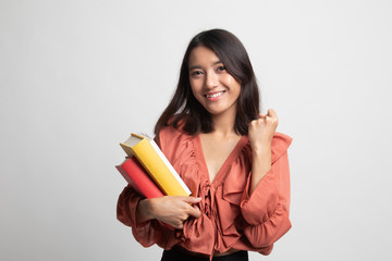 Young Asian woman studying  with may books .