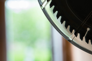 Silhouette of a miter saw blade with plastic safety cover close up shot, copy space.
