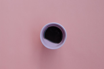 cup of coffee on a pink table