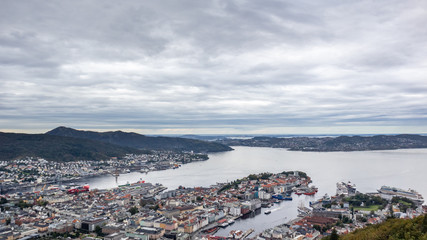Bergen and Northern sea panoramic aerial view from Floyen attraction hiking area on cloudy grey cold day. Bergen, Norway 