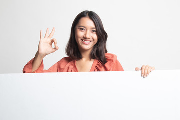 Fototapeta premium Young Asian woman show OK with blank sign .