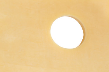 close up of hole in piece of cheese