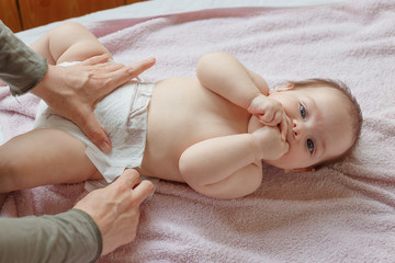 Fototapeta na wymiar Top View Mom Changing Diaper To Baby