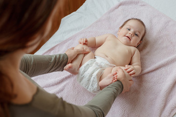 mother does back and a foot massage to a newborn baby. mother's care. healthy lifestyle.