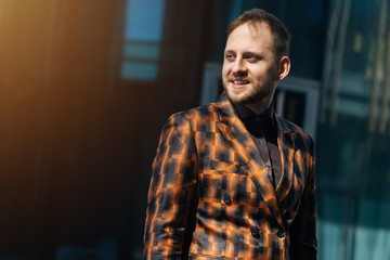 Portrait of a beautiful Caucasian male bineman in a business suit against a dark background. Text writing space