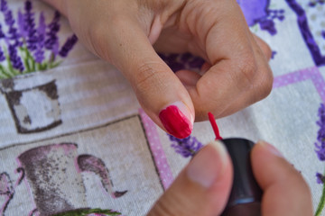 Fototapeta premium Woman painting his nails red