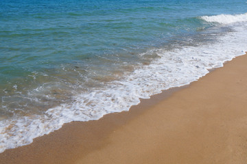 Fototapeta na wymiar sea ​​beach closeup, sand and white waves 