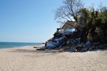 the ruins of a brick house destroyed by a landslide and the sea
