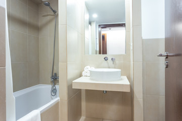 Fototapeta na wymiar Modern bathroom with bathtub, mirror and washbasin. hotel design.