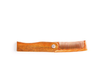 Folding wooden comb on a white background.