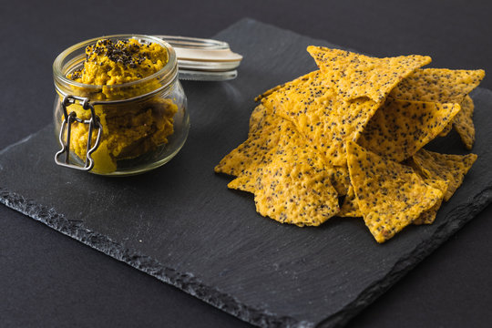 Healthy Homemade Hummus With Curry And Pita Chips Isolated On Blackboard