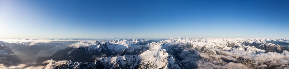 Aerial Panoramic View of Remote Canadian Mountain Landscape during sunny sunrise. Located near Vancouver, British Columbia, Canada. Nature Panorama Background. Authentic