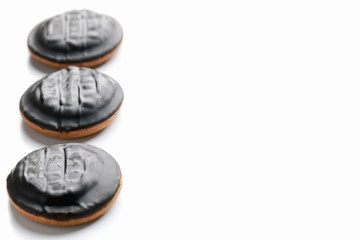 Top view of round chocolate homemade cookies in a row on a white background with a large space. Concept of making desserts and baking