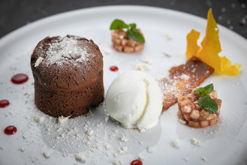 
chocolate fondant with ice cream on a white plate