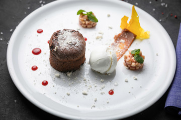 
chocolate fondant with ice cream on a white plate