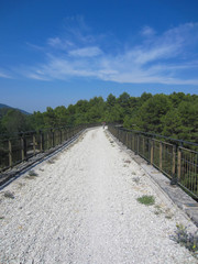 Fototapeta na wymiar View of the bridge of the mtb bike trail Spoleto Norcia that goes on the track of a former railway (ex ferrovia) in Umbria, Italy