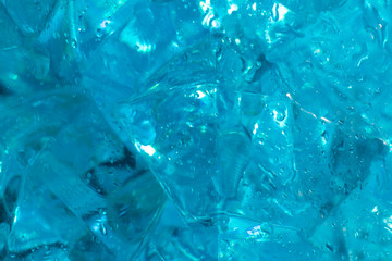 texture of ice on blue backgrouTexture and background of blue crystals with ice in drops of fresh water. Classic blue background.nd