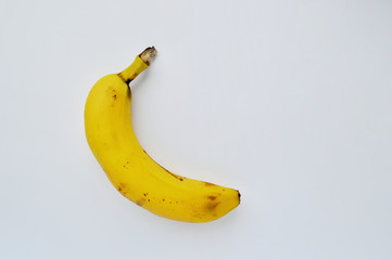 Single yellow banana on a white background.