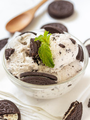 Chocolate cookie and ice cream in a glass bowl with mint leaf on white wooden background, summer sweet and dessert