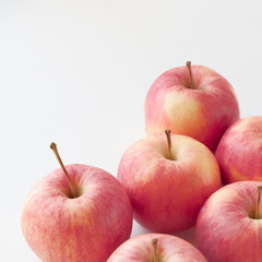 Close-up of red apples fresh and juicy on a white background. Fruit composition, vitamin food poster, apple peel details. Square with selective focus, copy space for text.