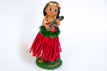 Hula dancer doll (girl) with ukulele on the white background