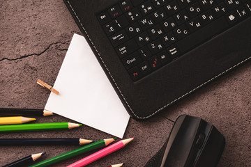 laptop and notes with pencils