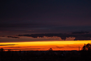 the sun sets on the horizon