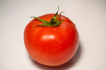 Red tomato on the white background