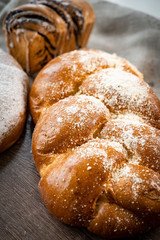 Fresh bakery, sliced bread on a wooden backround