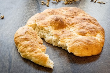 Fresh bakery, sliced bread on a wooden backround